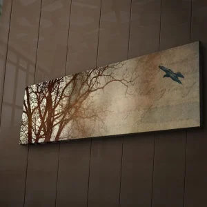Outlet Canvastavla med LED-belysning 30x90 cm - Silhuett av träd med en fågel i flykt mot en mjukt tonad bakgrund Mörkbrun / Beige / Svart - Inredning