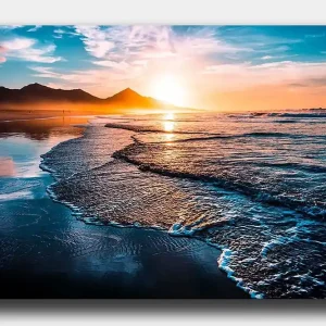 Canvastavla 70x100 cm - Solnedgång över en strand med mjuka vågor som rullar in mot kusten - Inredning & dekor Extra rabatt